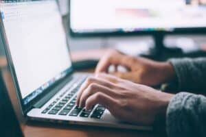glenn-carstens-peters-npxXWgQ33ZQ-unsplash hands typing on laptop keyboard